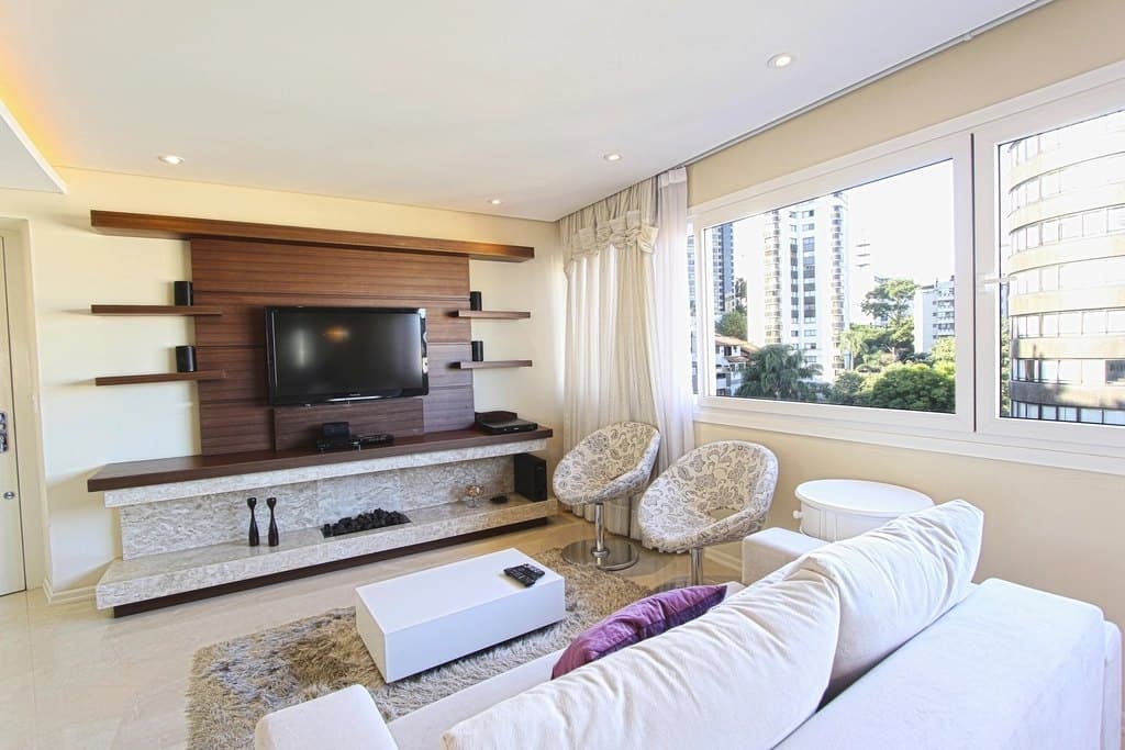 Modern living room with wall-mounted TV unit and city view